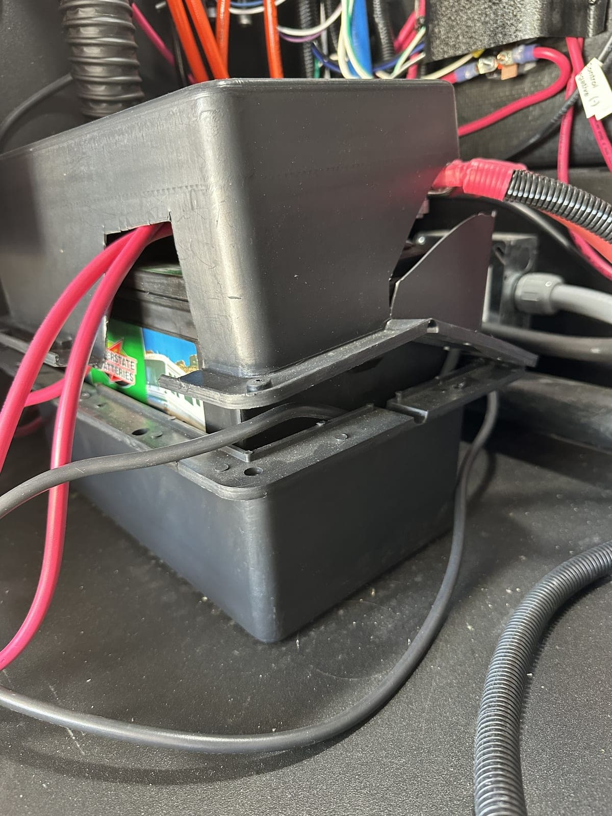 Factory-installed lead-acid battery system with poor craftsmanship and unprofessional wiring — typical "inherited" state before repair work