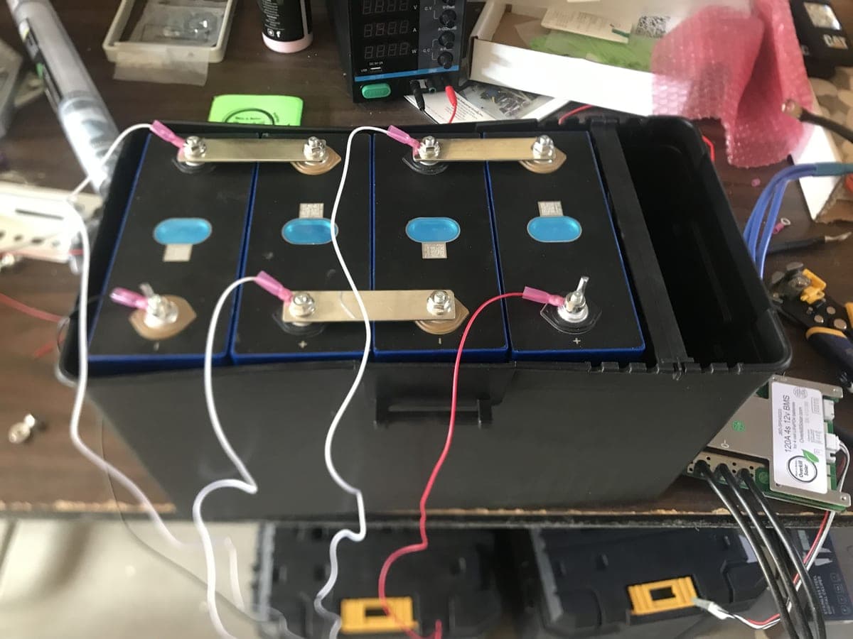 Custom LiFePO4 battery pack assembly in progress with cell balancing tooling